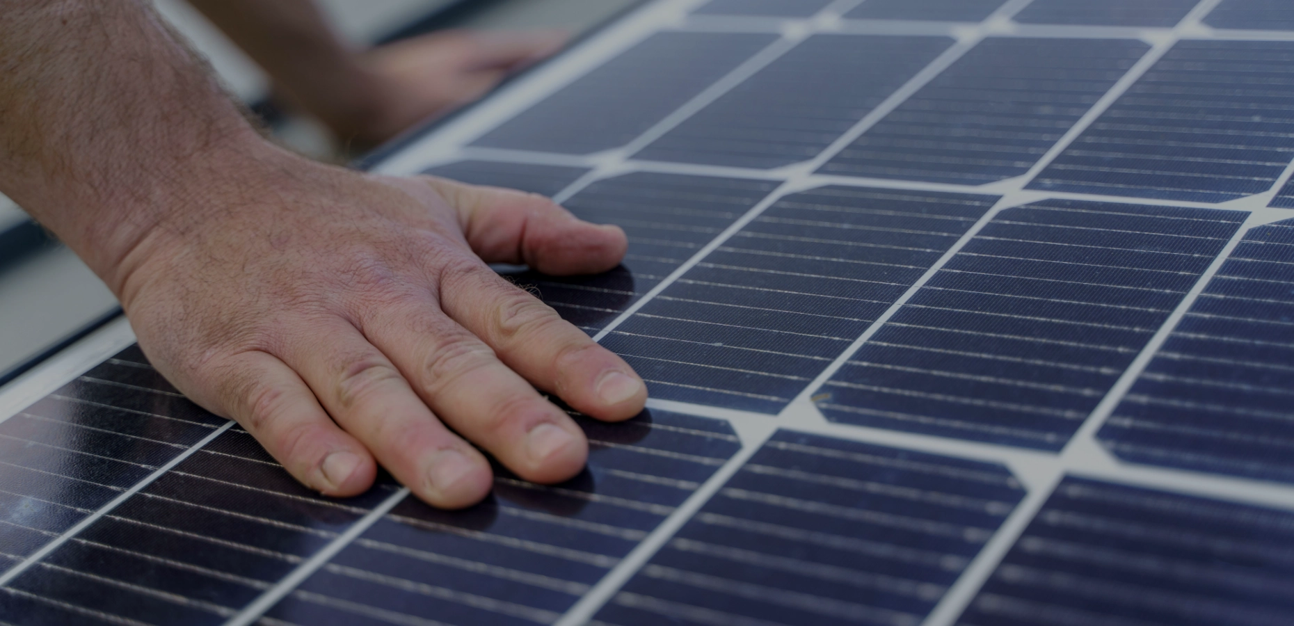 Hand on a solar panel